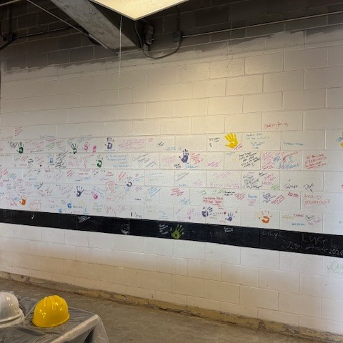 Community signatures and handprints on the Milliken Library wall